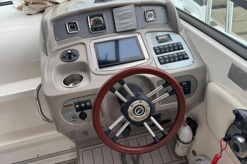 Slide: The Image of 2009 Chaparral Signature 250 boat dashboard with Garmin navigation system and wooden steering wheel. - 18