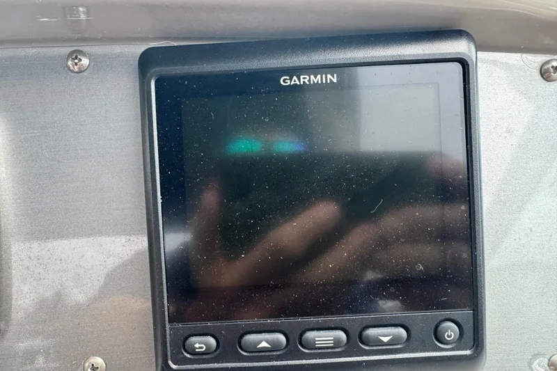 Slide: The Image of Garmin device on 2009 Chaparral Signature 250 dashboard, featuring control buttons. - 23