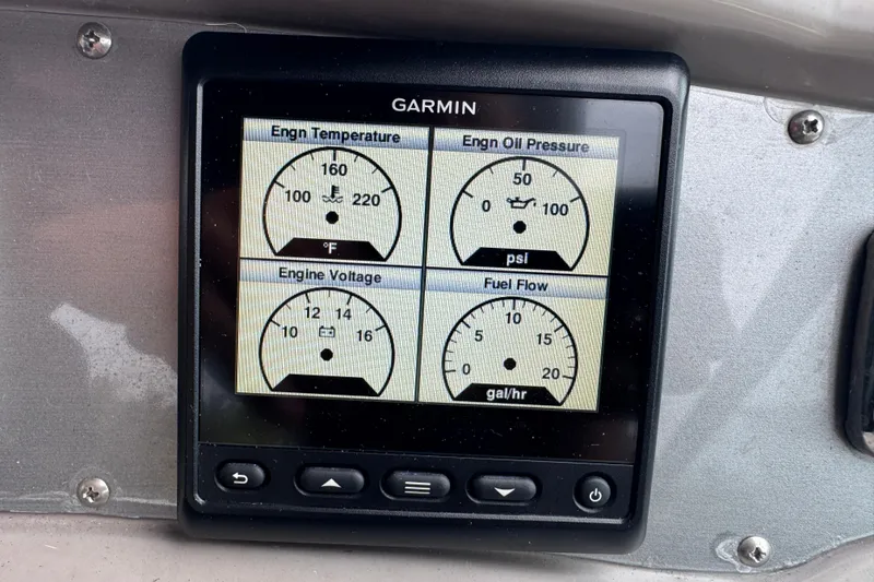 Slide: The Image of Garmin display showing engine metrics on 2009 Chaparral Signature 250 boat dashboard. - 24