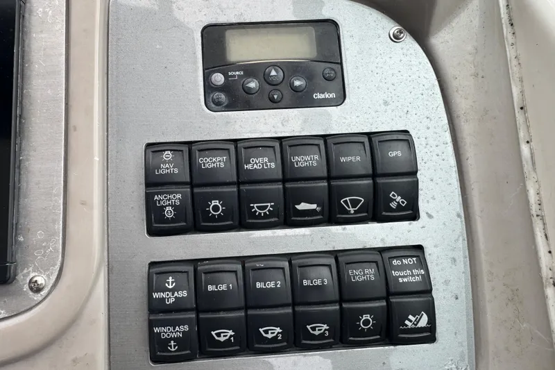 Slide: The Image of Control panel of a 2009 Chaparral Signature 250 boat with various switches and buttons. - 26