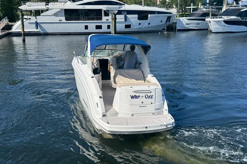 Slide: The Image of 2009 Chaparral Signature 250 boat with blue canopy cruising in marina. - 3