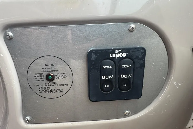 Slide: The Image of Control panel on a 2009 Chaparral Signature 250 boat with Lenco trim tab switches. - 30
