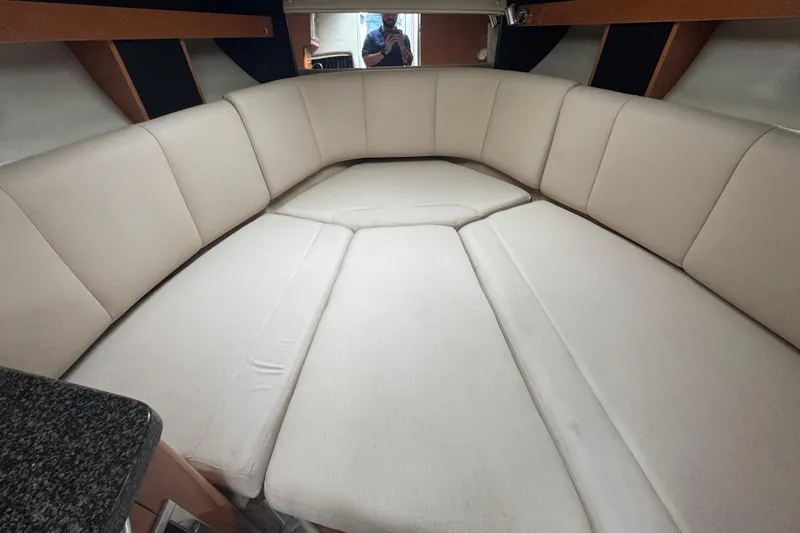 Slide: The Image of 2009 Chaparral Signature 250 interior with beige seating and modern design. - 34