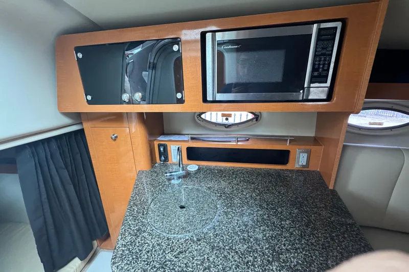 Slide: The Image of 2009 Chaparral Signature 250 interior kitchen with microwave and granite countertop. - 37