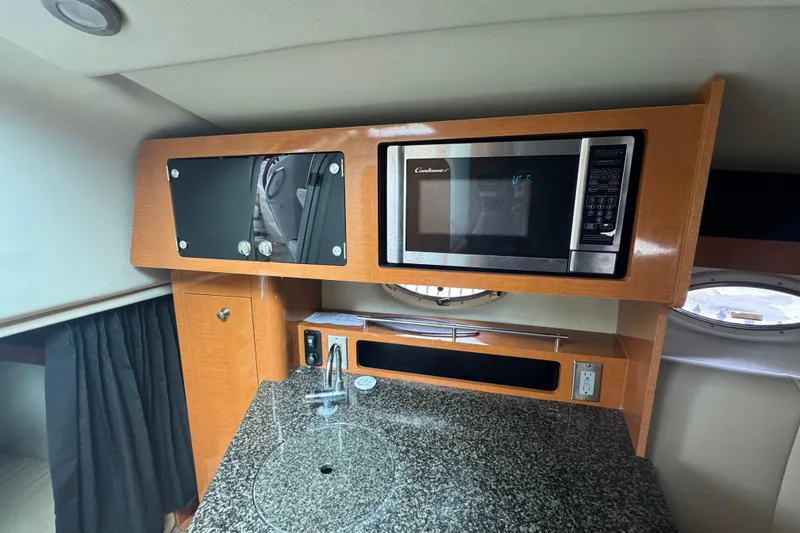 Slide: The Image of 2009 Chaparral Signature 250 interior with microwave, sink, and granite countertop. - 39