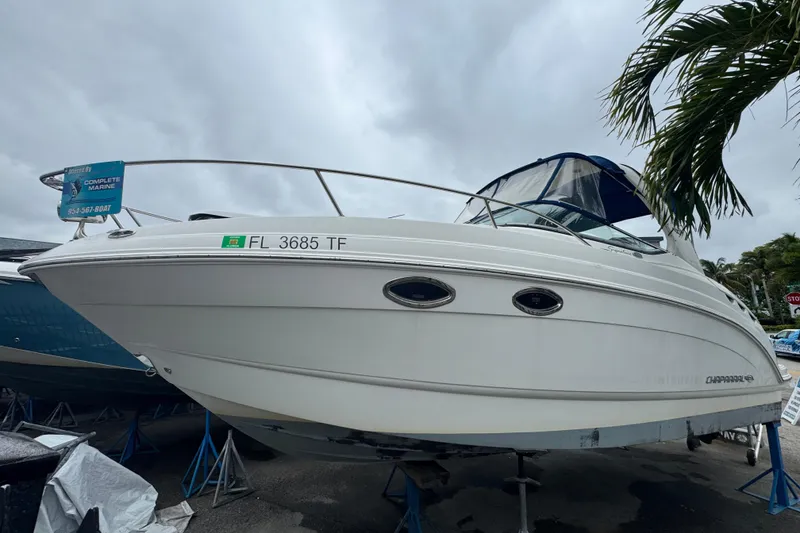 Slide: The Image of 2009 Chaparral Signature 250 boat on display, white hull, parked outdoors. - 45