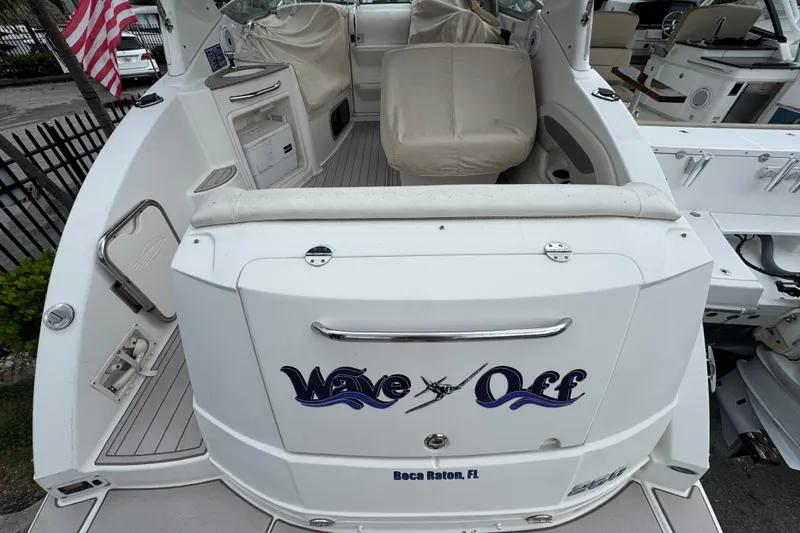 Slide: The Image of 2009 Chaparral Signature 250 boat with "Wave Off" text, docked in Boca Raton, FL. - 7