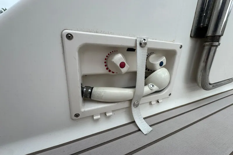 Slide: The Image of 2009 Chaparral Signature 250 boat shower controls with hot and cold knobs. - 9