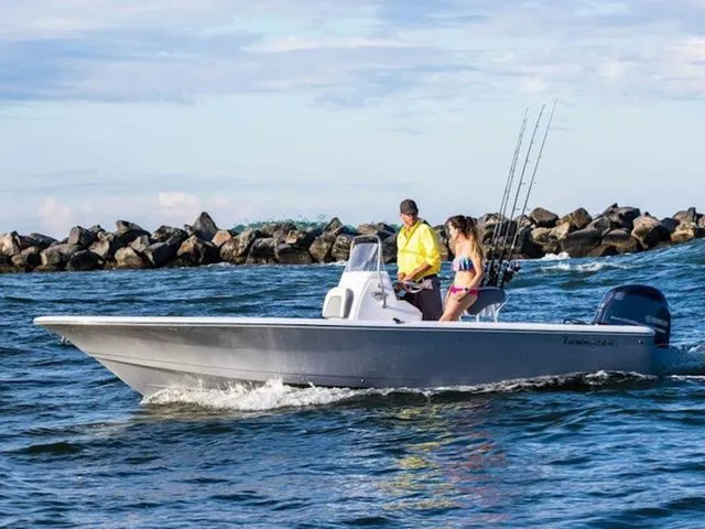 The Image of Tidewater 1910 Bay Max 2026 boat on water with two people. - 1