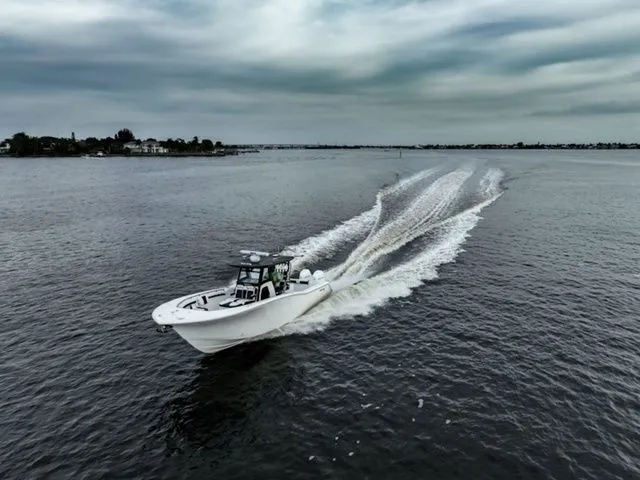 The Image of Tidewater 320 CC Adventure 2026 cruising on open water under cloudy skies. - 1