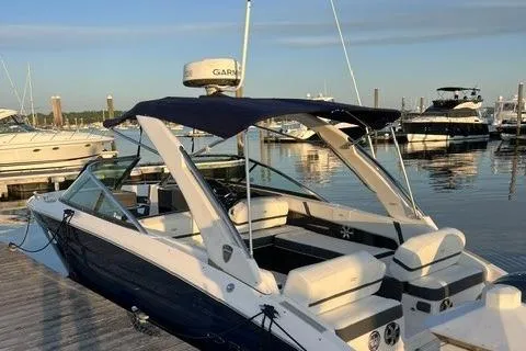 Slide: The Image of 2017 Regal 29 OBX boat docked at marina with other vessels in background. - 2