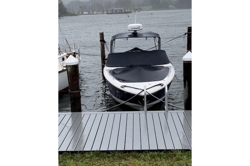 Slide: The Image of 2017 Regal 29 OBX boat docked on a rainy day with cover on. - 3