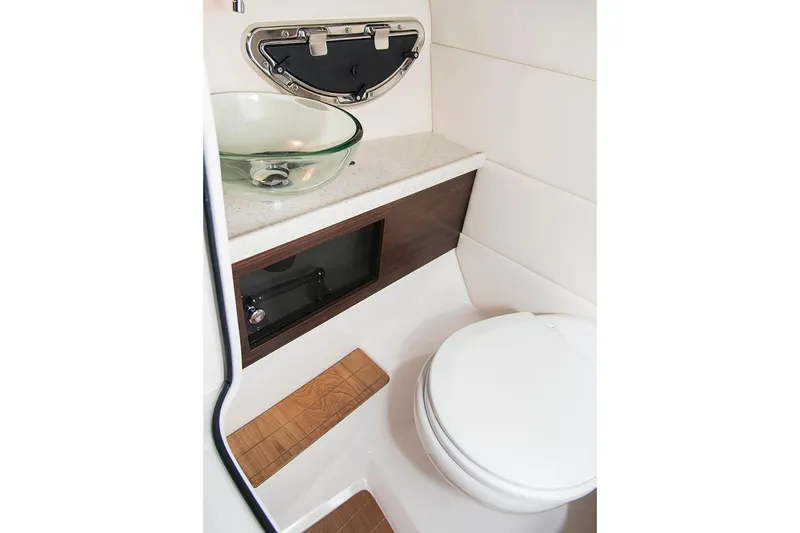 Slide: The Image of Manufacturer Provided Image: 2017 Regal 29 OBX boat bathroom with modern sink and toilet. - 7