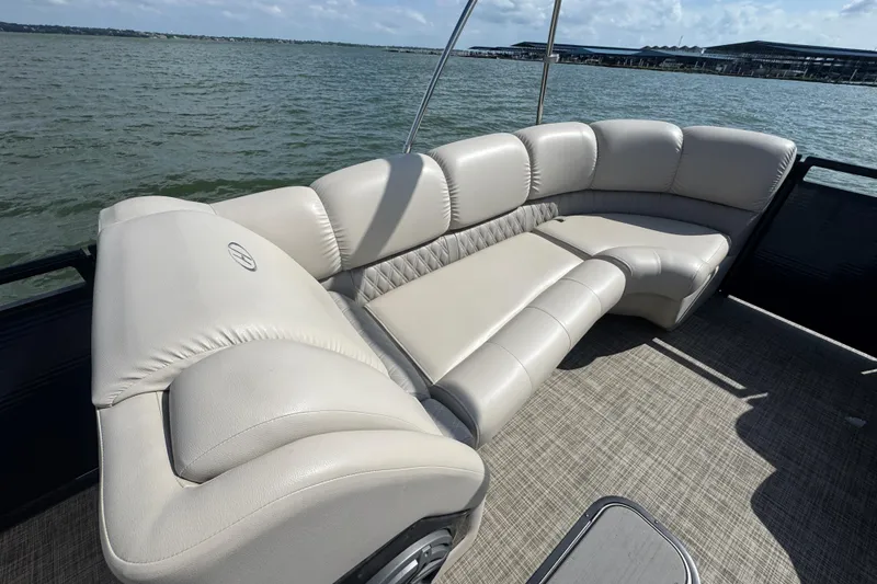 Slide: The Image of Luxurious seating on 2019 Harris Solstice 220 pontoon boat, overlooking serene lake waters. - 10