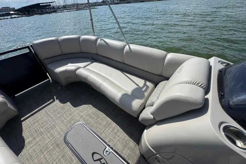 Slide: The Image of Luxurious seating on a 2019 Harris Solstice 220 pontoon boat, overlooking serene waters. - 11