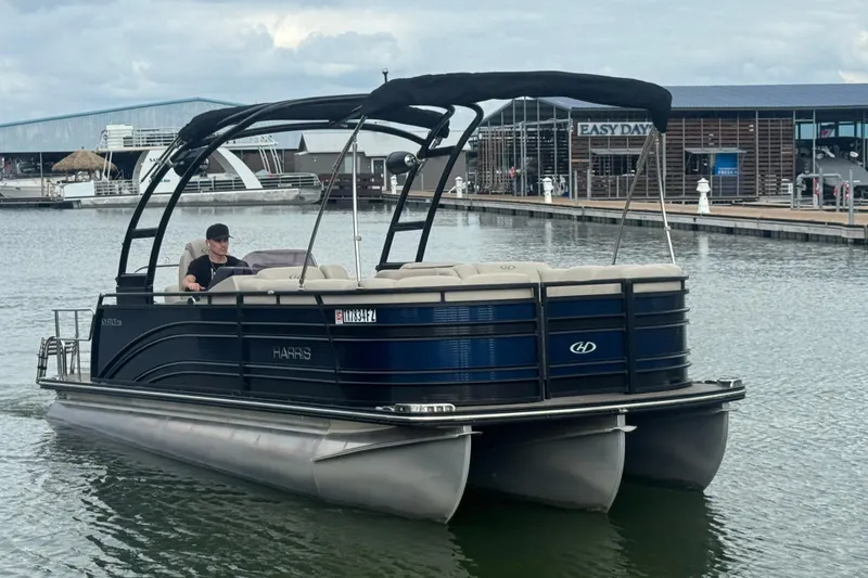 Slide: The Image of 2019 Harris Solstice 220 pontoon boat cruising near a marina. - 4