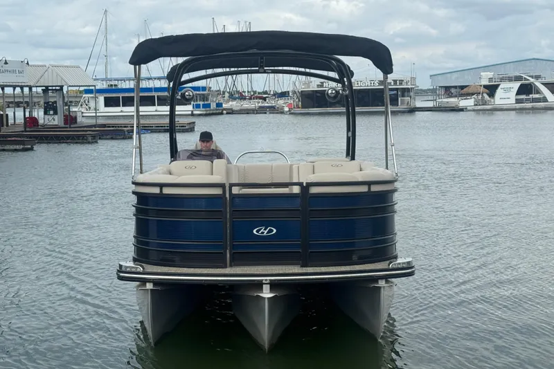 Slide: The Image of 2019 Harris Solstice 220 pontoon boat docked at marina with overcast sky. - 5