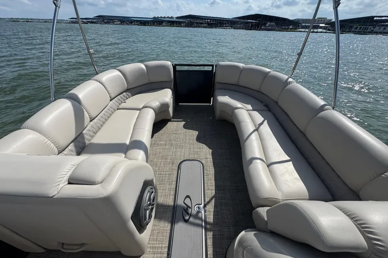 Slide: The Image of 2019 Harris Solstice 220 pontoon boat interior with beige seating on a sunny day. - 8