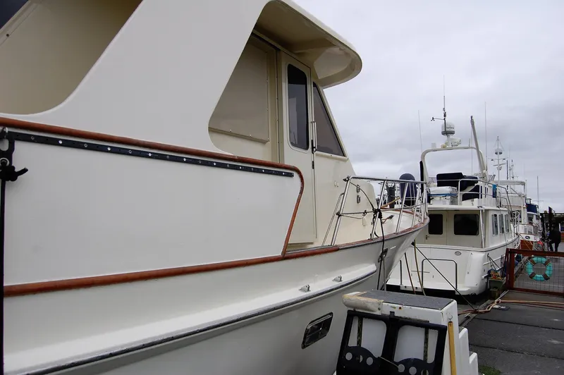Slide: The Image of 1982 Kong & Halvorsen Island Gypsy yacht docked at harbor. - 1