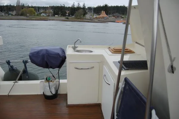 Slide: The Image of 1982 Kong & Halvorsen Island Gypsy with outdoor kitchen and water view. - 16