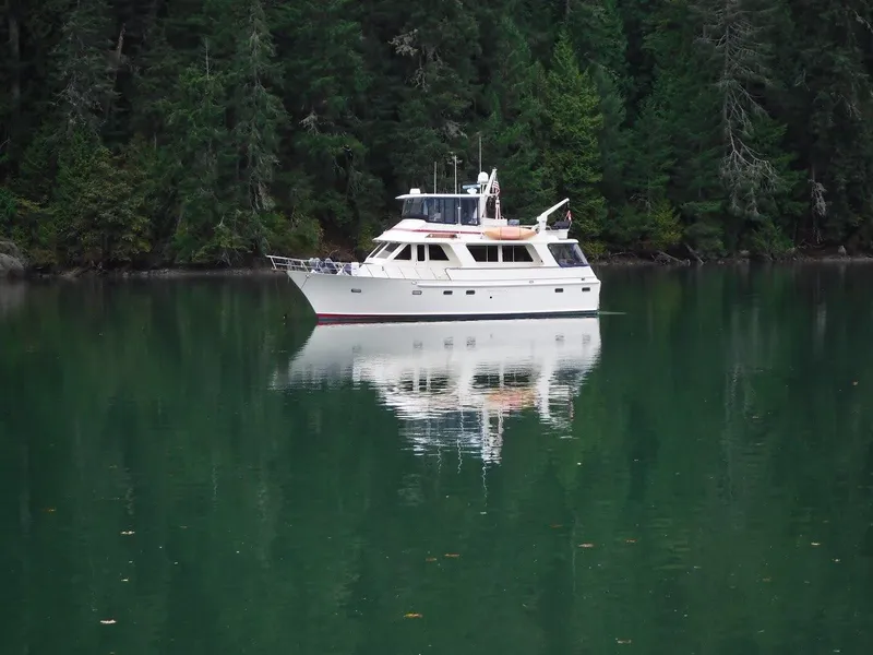 Slide: The Image of 1982 Kong & Halvorsen Island Gypsy yacht on calm water near forest. - 2