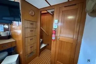 Slide: The Image of 1982 Kong & Halvorsen Island Gypsy interior with wooden cabinetry and nautical decor. - 25