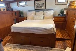 Slide: The Image of Luxurious 1982 Kong & Halvorsen Island Gypsy yacht bedroom with wood accents and cozy bedding. - 26