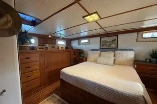 Slide: The Image of 1982 Kong & Halvorsen Island Gypsy yacht bedroom with wooden interior and cozy bed. - 29