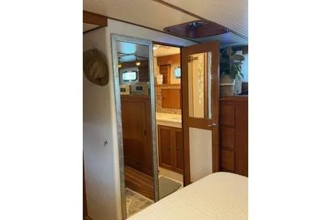 Slide: The Image of 1982 Kong & Halvorsen Island Gypsy yacht interior with wood paneling and mirrored door. - 31