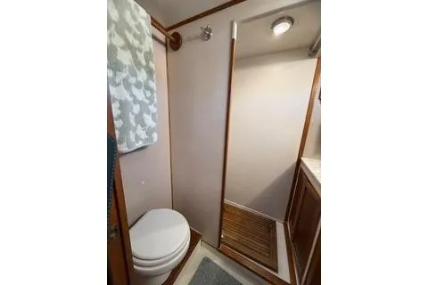 Slide: The Image of 1982 Kong & Halvorsen Island Gypsy yacht bathroom with shower, toilet, and wooden accents. - 34