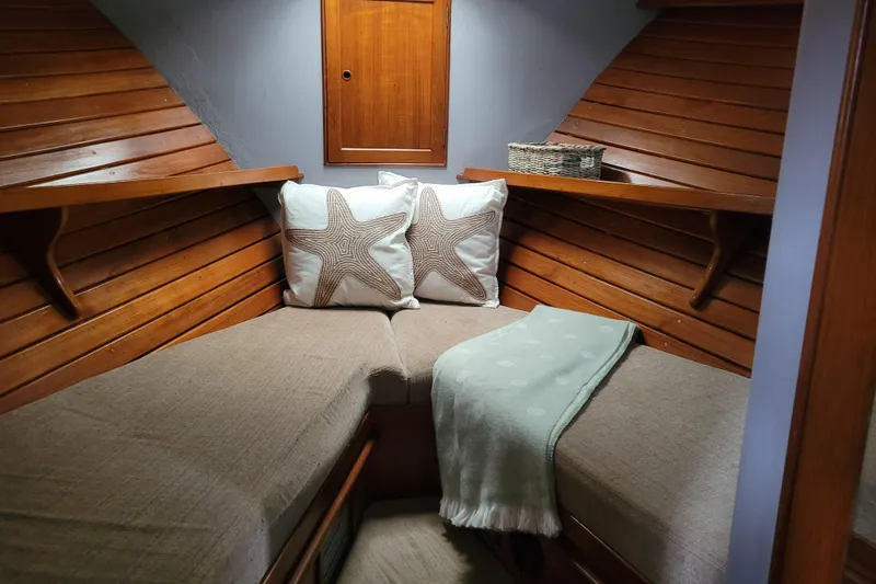 Slide: The Image of Cozy cabin interior of 1982 Kong & Halvorsen Island Gypsy with starfish pillows and wooden paneling. - 43
