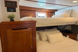 Slide: The Image of Cozy cabin interior of 1982 Kong & Halvorsen Island Gypsy yacht with wooden accents and bedding. - 48