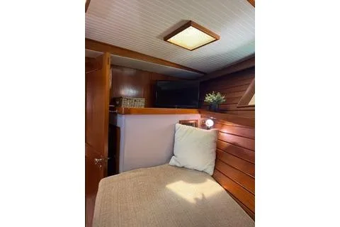 Slide: The Image of 1982 Kong & Halvorsen Island Gypsy cabin interior with cozy bed and wooden paneling. - 50