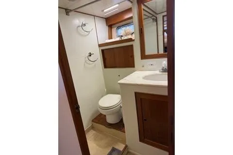 Slide: The Image of 1982 Kong & Halvorsen Island Gypsy yacht bathroom with wooden cabinetry and modern fixtures. - 51