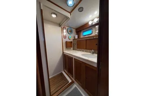 Slide: The Image of 1982 Kong & Halvorsen Island Gypsy yacht bathroom with wooden cabinetry and modern fixtures. - 52