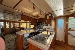 Slide: The Image of 1982 Kong & Halvorsen Island Gypsy yacht interior with wooden kitchen and modern amenities. - 63