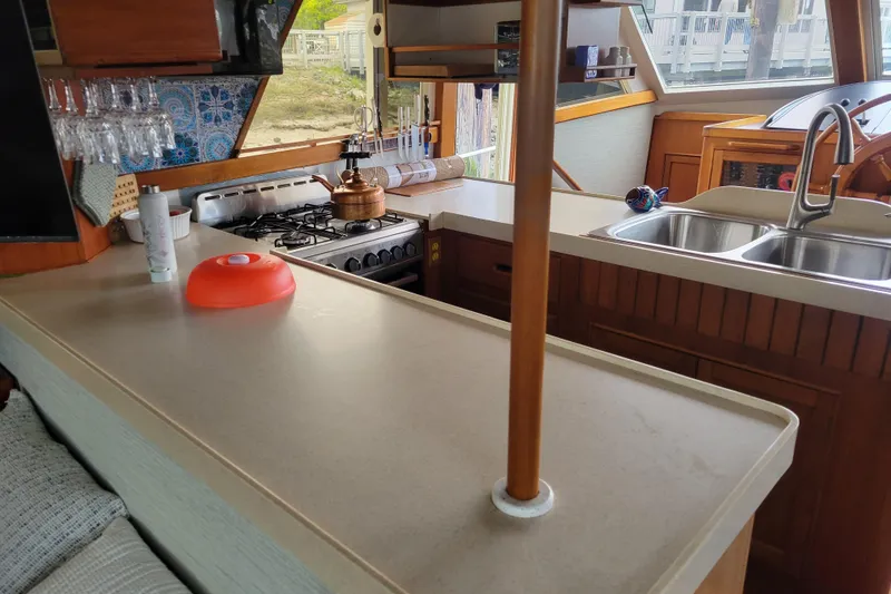 Slide: The Image of Interior of 1982 Kong & Halvorsen Island Gypsy yacht kitchen with stove, sink, and counter. - 67