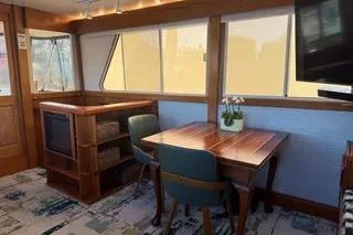 Slide: The Image of 1982 Kong & Halvorsen Island Gypsy yacht interior with dining area and wooden furnishings. - 70