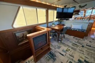 Slide: The Image of 1982 Kong & Halvorsen Island Gypsy yacht interior with cozy seating, TV, and nautical decor. - 72