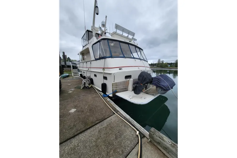 Slide: The Image of 1982 Kong & Halvorsen Island Gypsy yacht docked at marina, overcast sky. - 76