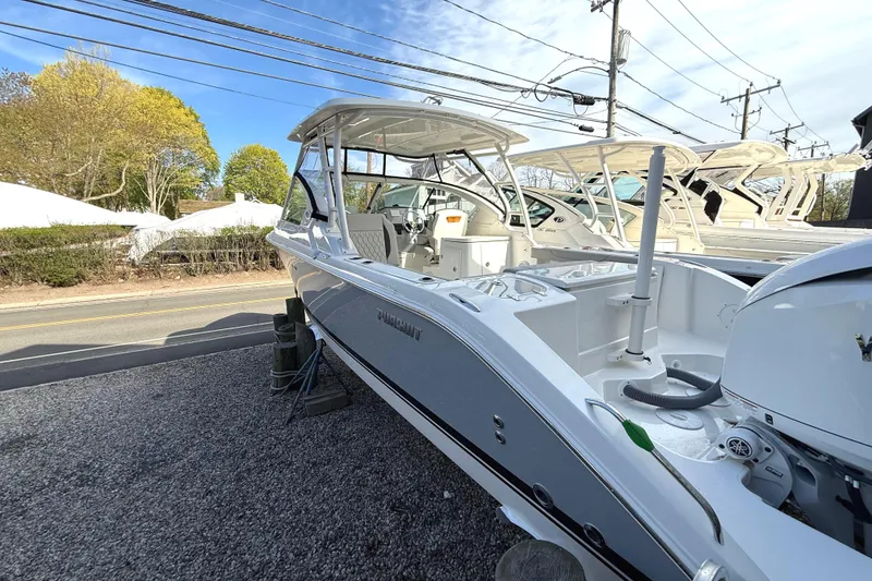 Slide: The Image of 2026 Pursuit DC 266 Dual Console boat on gravel lot. - 3