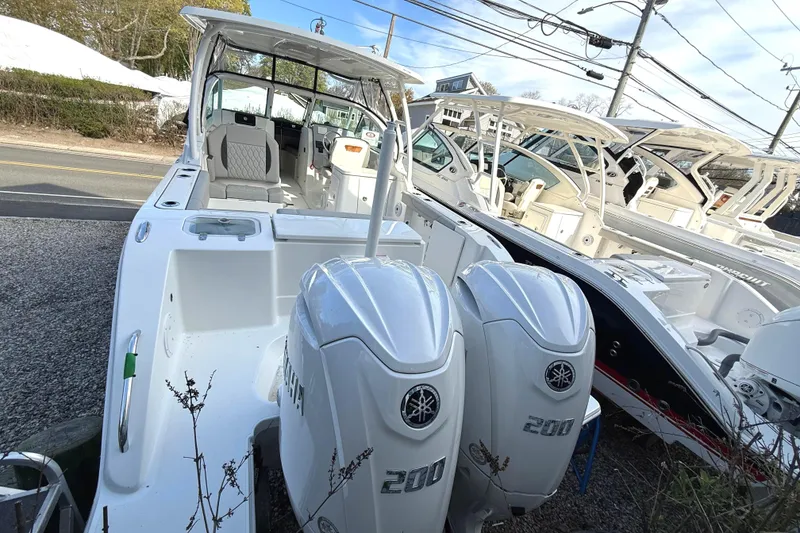 Slide: The Image of 2026 Pursuit DC 266 Dual Console with twin outboard engines. - 4