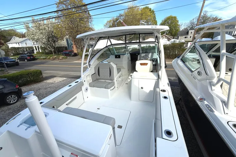 Slide: The Image of 2026 Pursuit DC 266 Dual Console boat on a parking lot. - 5
