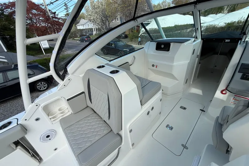 Slide: The Image of 2026 Pursuit DC 266 Dual Console interior with seating and helm, showcasing modern design. - 6