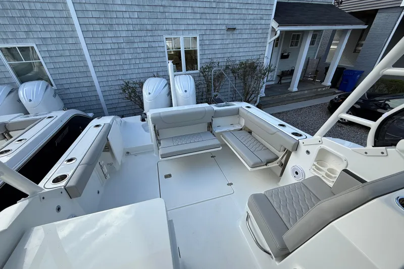 Slide: The Image of 2026 Pursuit DC 266 Dual Console boat interior with seating and outboard motors. - 7