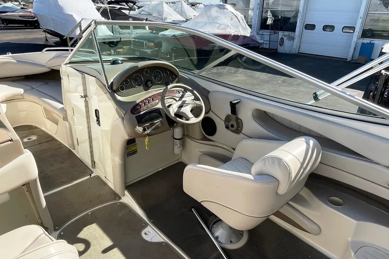 Slide: The Image of 2001 Maxum 2300 SR boat interior with steering wheel and seating. - 3