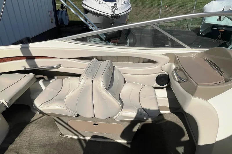 Slide: The Image of Interior of a 2001 Maxum 2300 SR boat with beige seating and dashboard. - 4