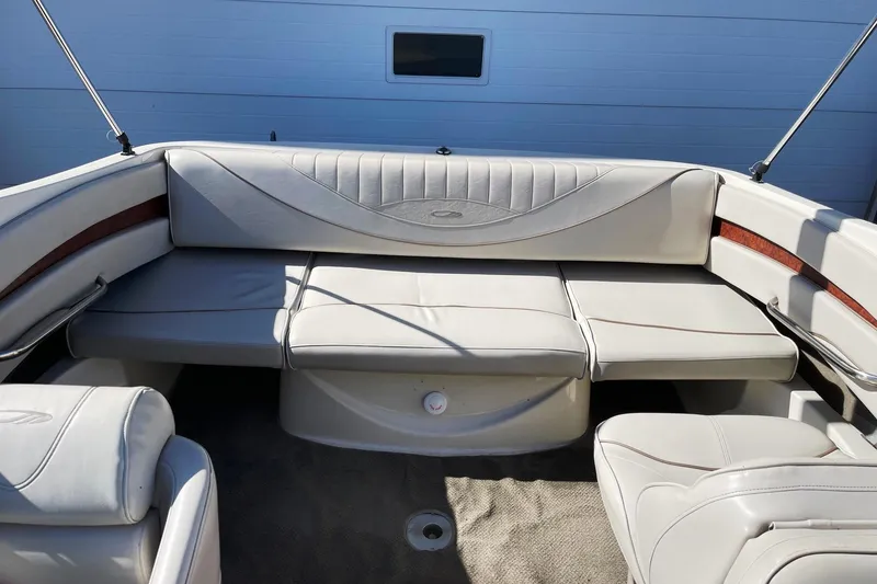 Slide: The Image of 2001 Maxum 2300 SR boat interior with white leather seating and wood accents. - 5