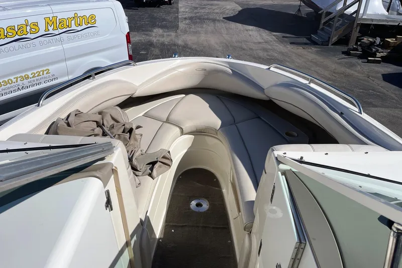 Slide: The Image of 2001 Maxum 2300 SR boat interior with beige seating and open deck view. - 6