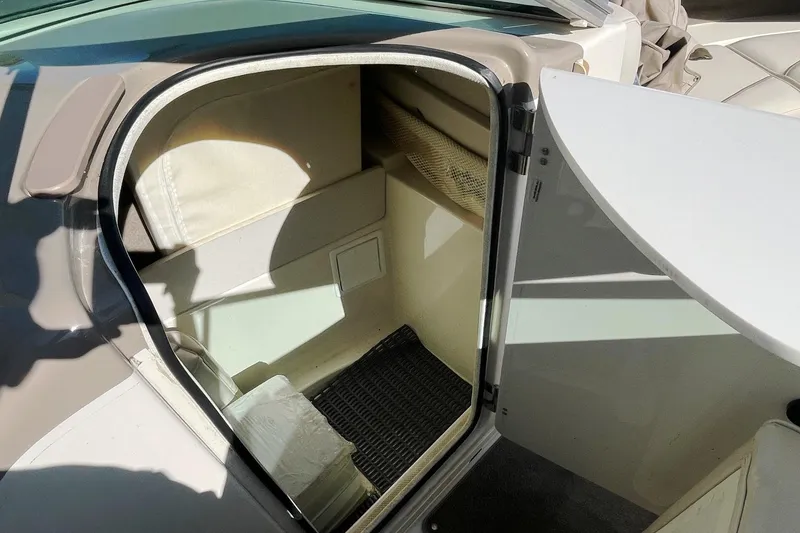 Slide: The Image of 2001 Maxum 2300 SR boat cabin interior with open door, showing storage space. - 7